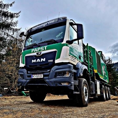 Lkw steht auf Waldboden.